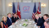 US President Donald Trump (2nd L) and Britain's Prime Minister Boris Johnson (3rd R) attend a working breakfast in Biarritz, south-west France on August 25, 2019, on the second day of the annual G7 Summit attended by the leaders of the world's seven riche