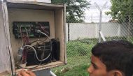Ninth grader Vamshi Voggu at the automatic weather station on the school premises in Kothapally, India, on July 31, 2019. Thomson Reuters Foundation/Roli Srivastava