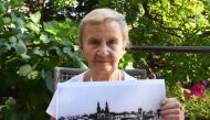 Zofia Burchacinska, an eyewitness to the bombing of Wielun holds a picture of the destroyed town on August 20, 2019. AFP / Janek Skarzynski