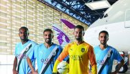 Al Sadd players sporting new team jerseys, featuring Qatar Airways logo.