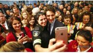 Canada's Prime Minister Justin Trudeau poses with airport staff as they await Syrian refugees to arrive at the Toronto Pearson International Airport in Mississauga, Ontario, December 10, 2015. Reuters/Mark Blinch