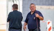 This picture taken on August 28, 2019 shows snake experts of the public order office at work in front of a residential building in Herne, western Germany, where a deadly cobra was on the loose. AFP / DPA / Christoph Reichwein 