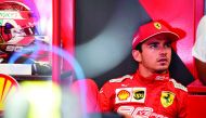 Ferrari's Monegasque driver Charles Leclerc looks on in the pits during the second practice session at the Spa-Francorchamps circuit in Spa on August 30, 2019 ahead of the Belgian Formula One Grand Prix. AFP / Kenzo Tribouillard

