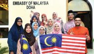 Malaysian students at various universities in Qatar holding their national flag during a function to celebrate the National Day of Malaysia at the Embassy of Malaysia in Doha, on Friday. 
Pics: Salim Matramkot / The Peninsula
