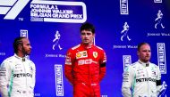 Winner Ferrari's Monegasque driver Charles Leclerc (C), second placed Mercedes' British driver Lewis Hamilton (L) and third placed Mercedes' Finnish driver Valtteri Bottas (R) celebrate on the podium after the Belgian Formula One Grand Prix at the Spa-Fra