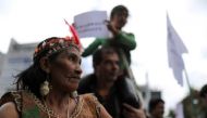 An indigenous woman looks on as she attends a protest outside the Brazilian embassy due to the wildfires in the Amazon rainforest, in Bogota, Colombia August 23, 2019. Reuters/Luisa Gonzalez