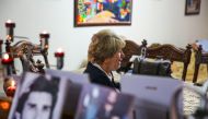 Samya Khasro, a woman from Iraq's once-persecuted Shiite Kurdish minority, sits next to pictures of family members who vanished 35 years prior and whose whereabouts remain unknown, as she gives an interview with AFP at her home in the capital Baghdad's hi