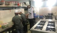 A chef guides two employees - former trafficking victims - in the kitchen of Maiti Cafe in Kathmandu, Nepal, August 16, 2019. Thomson Reuters Foundation/Gopal Sharma