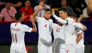 (FromL) Portugal's midfielder Bruno Fernandes, Portugal's defender Ruben Dias and Portugal's forward Cristiano Ronaldo celebrate a goal during the EURO 2020 football qualification match between Serbia and Portugal in Belgrade, Serbia, on September 7, 2019
