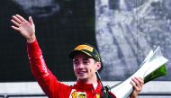 Winner Ferrari's Monegasque driver Charles Leclerc celebrates with his trophy on the podium after the Italian Formula One Grand Prix at the Autodromo Nazionale circuit in Monza on September 8, 2019. AFP / Miguel Medina
