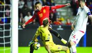 Spain's forward Rodrigo (top) scores his second goal during the UEFA Euro 2020 qualifier group F football match between Spain and Faroe Islands at El Molinon stadium in Gijon on September 8, 2019.  AFP / Miguel Riopa

