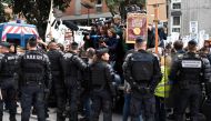 Journalists take photographs and videos above policemen as ecology activists demonstrate in front of Paris' courthouse in support of eight of them and one video journalist charged with 