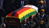 A casket carrying the remains of former Zimbabwean president Robert Mugabe is carried to the military chopper after his body lied in state at the Rufaro stadium, in Mbare, Harare, Zimbabwe, September 13, 2019. Reuters/Siphiwe Sibeko