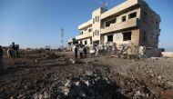 Syrian onlookers gather at the scene of a reported Russian airstrike in the village of al-Daher in Syria's northwestern Idlib province on September 11, 2019.   AFP / Omar HAJ KADOUR
