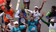 Activist and treegrower Siyabulela Sokomani celebrates as he approaches the final stretch of the Cape Town marathon, in South Africa September 15, 2019. REUTERS/Mike Hutchings