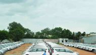 In this photograph taken on September 11, 2019, a security guard patrols a holding area for new vehicles near a godown on the outskirts of Hyderabad. AFP / Noah Seelam