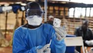 A health worker prepares to administer Ebola vaccine outside the house of a victim who died in the village of Mangina in North Kivu province, Democratic Republic of Congo, August 18, 2018. Reuters/Olivia Acland