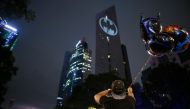 A fan man looks at Batman's symbol projected over the Reforma Tower on the 80th anniversary of US comics fictional superhero in Mexico City, on September 21, 2019. / AFP / ALFREDO ESTRELLA