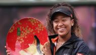 Pan Pacific Open women's singles winner Naomi Osaka holds a victory plate during the awarding ceremony in Osaka on September 22, 2019. - Japan OUT / AFP / JIJI PRESS / Jiji Press