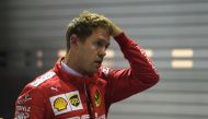 Ferrari's German driver Sebastian Vettel reacts after finishing in the third pole position in the qualifying session for the Formula One Singapore Grand Prix at the Marina Bay Street Circuit in Singapore on September 21, 2019. AFP / Mohd Rasfan 