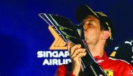 Sebastian Vettel kisses the trophy on the podium after winning the Formula One Singapore Grand Prix night race at the Marina Bay Street Circuit in Singapore on September 22, 2019.  AFP / Mohd Rasfan
