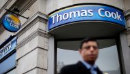 FILE PHOTO: A pedestrian walks past a Thomas Cook shop in central London, November 26, 2014. REUTERS/Suzanne Plunkett/File Photo