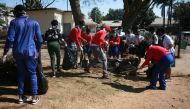 Students clean the streets of Harare Zimbabwe, September 5, 2019. Thomson Reuters Foundation/Tonderayi Mukeredzi