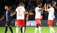 Reims' French midfielder Boulaye Dia (2ndR), Reims' Moroccan defender Yunis Abdelhamid (2ndL) and Reims' French midfielder Xavier Chavalerin (R) celebrate their victory past Paris Saint-Germain's Brazilian forward Neymar at the end of the French L1 footba