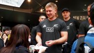 (FILES) In this file photo taken on September 22, 2019, New Zealand's All Blacks player Jack Goodhue (C) signs his autograph during a promotional event by tourism New Zealand in Tokyo, during the Japan 2019 Rugby World Cup. AFP / Toshifumi KITAMURA / 
