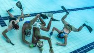 Players fighting for the puck during an underwater hockey training session ahead of the Southeast Asian (SEA) Games in the Philippines, at the National Aquatic Centre in Bukit Jalil, on August 26, 2019, on the outskirts of Kuala Lumpur.  AFP / Mohd Rasfan