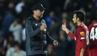 Liverpool's German manager Jurgen Klopp (L) reacts with Liverpool's Spanish midfielder Pedro Chirivella at the final whistle during the English League Cup third round football match between MK Dons and Liverpool at Stadium MK in Milton Keynes, Buckinghams
