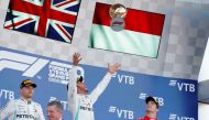 Mercedes' Lewis Hamilton celebrates with a trophy on the podium after winning the race alongside second placed Mercedes' Valtteri Bottas and third placed Ferrari's Charles Leclerc REUTERS/Maxim Shemetov