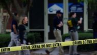 Federal agents are seen behind crime scene tape after executing search warrants on multiple businesses in Lawrenceville, Georgia U.S. September 27, 2019. Reuters/Elijah Nouvelage