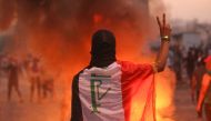 An Iraqi protester gestures the v-sign during a demonstration against state corruption, failing public services and unemployment at Tayaran square in Baghdad on October 2, 2019. AFP / AHMAD AL-RUBAYE