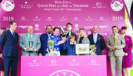 Raahah’s owner H H Sheikh Mohamed bin Khalifa Al Thani, jockey and the support team members celebrate with the trophy after winning the Gr1 PA Qatar Arabian Trophy Des Juments for four-year-old mares at ParisLongchamp on Day 1 of the Qatar Prix de l’Arc d