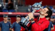 Novak Djokovic of Serbia kisses the trophy after winning. REUTERS/Kim Kyung-Hoon