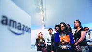 Job hunters wait to speak with Amazon recruiters at an Amazon Career Day event, where recruiters help candidates build interview skills, prepare them for job interviews and give them more information on the roles within the company, at Crystal City in Arl