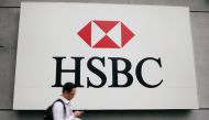A man walks past a logo of HSBC at its headquarters in Kuala Lumpur, Malaysia August 6, 2019. Picture taken August 6, 2019. REUTERS/Lim Huey Teng