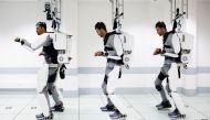 This handout combination of photographs taken on September 2019 and released on October 3, 2019, by Clinatec Endowment Fund (fonds de dotation Clinatec) shows French tetraplegic 'Thibault' as he stands while wearing an exo-skeleton at The University of Gr