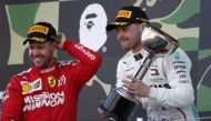 Mercedes' Valtteri Bottas celebrates with the trophy after winning the race alongside second placed Ferrari's Sebastian Vettel. REUTERS/Soe Zeya Tun