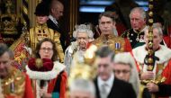 Britain's Queen Elizabeth II (C) and Britain's Prince Charles, Prince of Wales (top right) proceed through the Royal Gallery to deliver the Queen's speech at the State Opening of Parliament in the Houses of Parliament in London on October 14, 2019.   AFP 