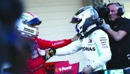 Winner Mercedes’ Finnish driver Valtteri Bottas (right) and second-placed Ferrari’s German driver Sebastian Vettel (left) congratulate one another after the Japanese Grand Prix final at Suzuka on Sunday.  