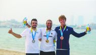 The podium winners of the men’s kitefoil racing event, Florian Gruber  (Germany, gold), Nicolas Parlier (France, silver) and Guy Bridge (Great Britain, bronze) pose for a photograph. Picture:  Laurel Photo Services