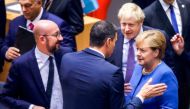 German Chancellor Angela Merkel (R), British Prime Minister Boris Johnson (2nd R), Spanish Prime Minister Pedro Sanchez (C) and Belgian Prime Minister Charles Michel (L) speak together upon their arrival to attend a round table meeting as part of a Europe