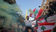Lebanese protesters take to the streets during demonstrations to demand better living conditions and the ouster of a cast of politicians who have monopolised power and influence for decades, on October 21, 2019 at Riad al-Solh Square in Beirut.  AFP / Anw