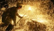In this file photo taken on April 12 2006 an iron and steel worker makes a test on a casting. AFP / Boris Horvat