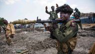 FILE PHOTO: Soldiers of the Sudan People Liberation Army celebrate while standing in trenches in Lelo outside Malakal, northern South Sudan on October 16, 2016. AFP / Albert Gonzalez Farran
