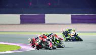 Chaz Davies of Aruba.it Racing-Ducati (front) takes a turn ahead of Jonathan Rea (centre) of Kawasaki Racing FIM WorldSBK Race 2 at the Losail International Circuit in this file picture.