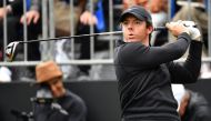 Rory McIlroy of Northern Ireland tees off at the first hole at a