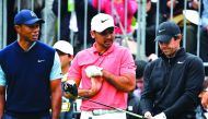 Tiger Woods of the US (L), Jason Day of Australia (C) and Rory McIlroy of Northern Ireland (R) chat at the first hole tee at a